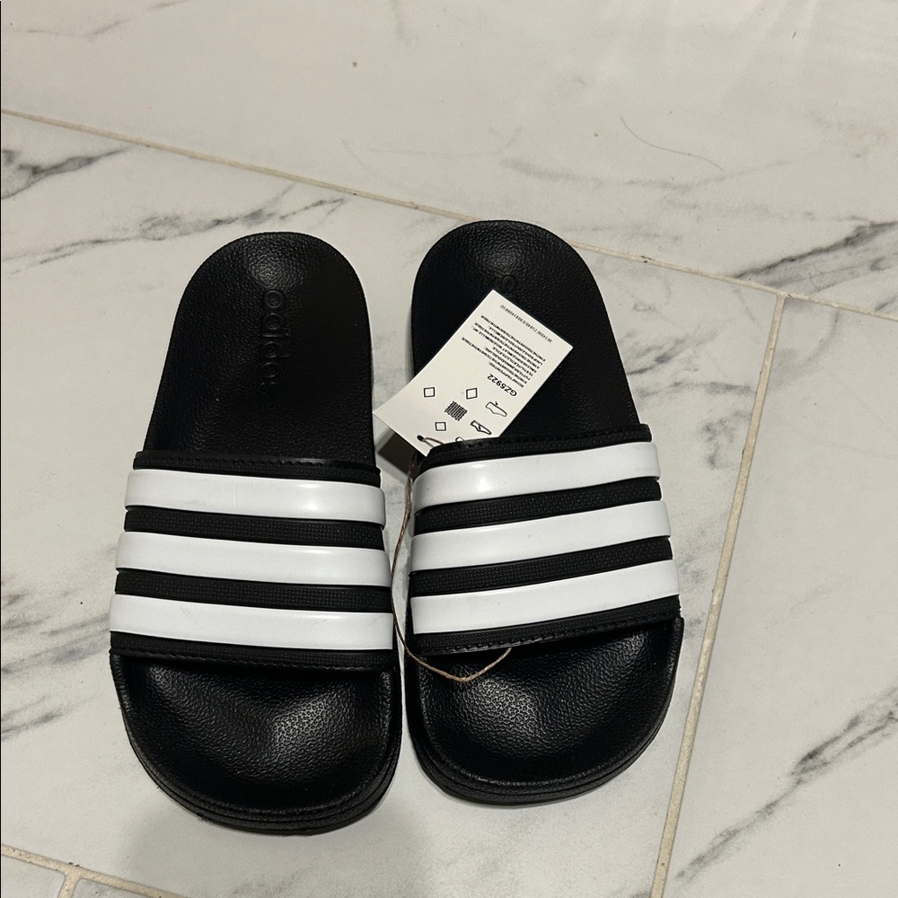 adidas Black and White Unisex Slide Sandals with Triple Stripes.